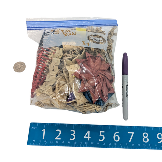 A bag of natural shred scraps, which could include palm, vine, seagrass, and more. By Lil Monsters Bird Toys. Shown next to a sharpie, ruler, and US quarter for scale