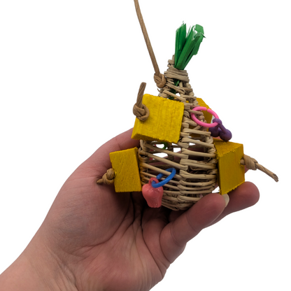 Pina Colada summer themed parrot toy by Lil Monsters Bird Toys, held in hand for scale