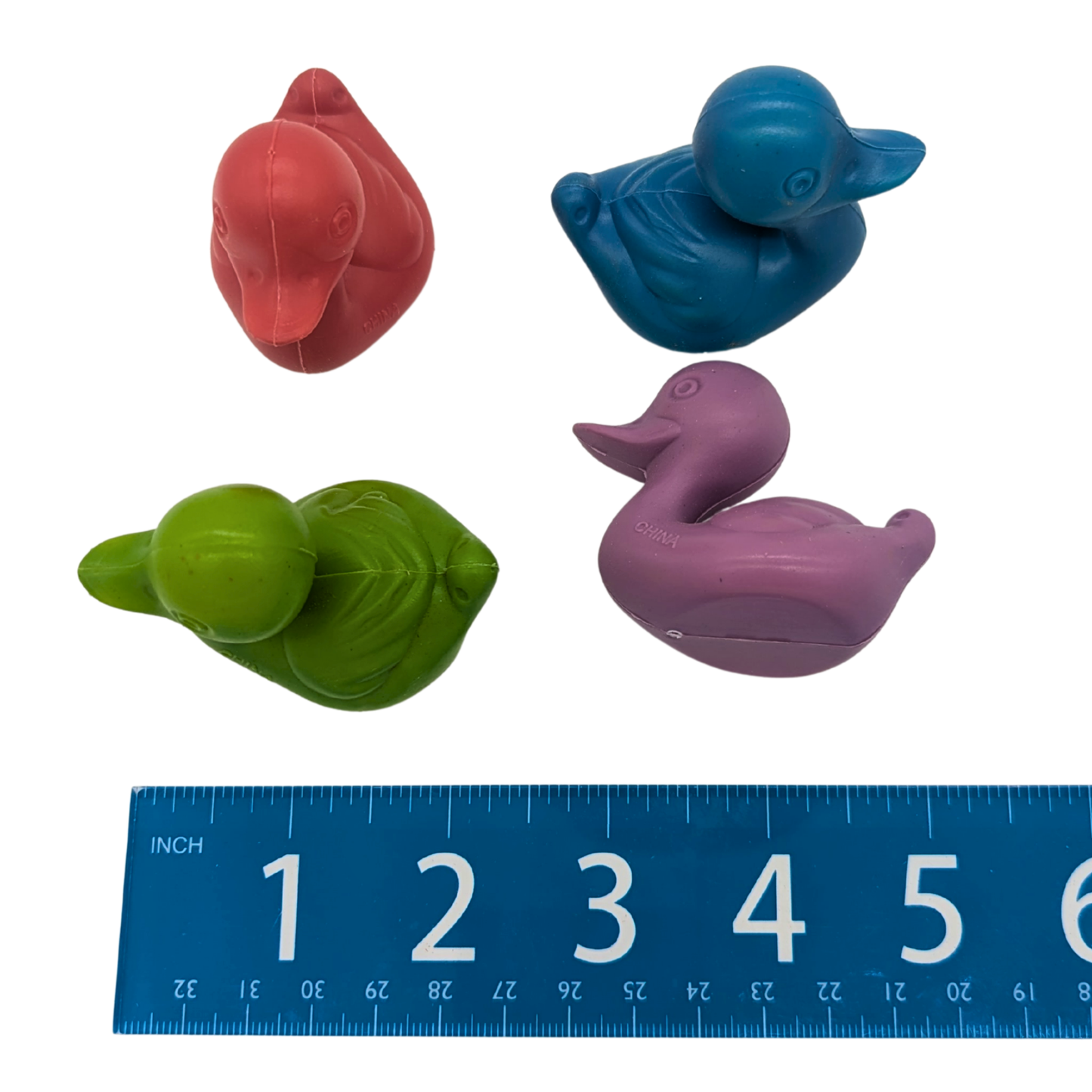 Plastic Duck 4 Pack by Lil Monsters Bird Toys, shown next to ruler for scale, top view