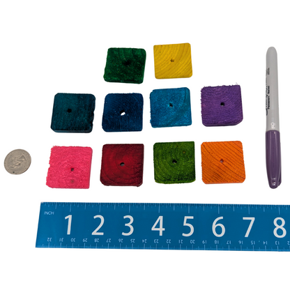 Quarter inch pine slices bird toy by Lil Monsters Bird Toys, next to a sharpie, ruler, and US quarter for scale