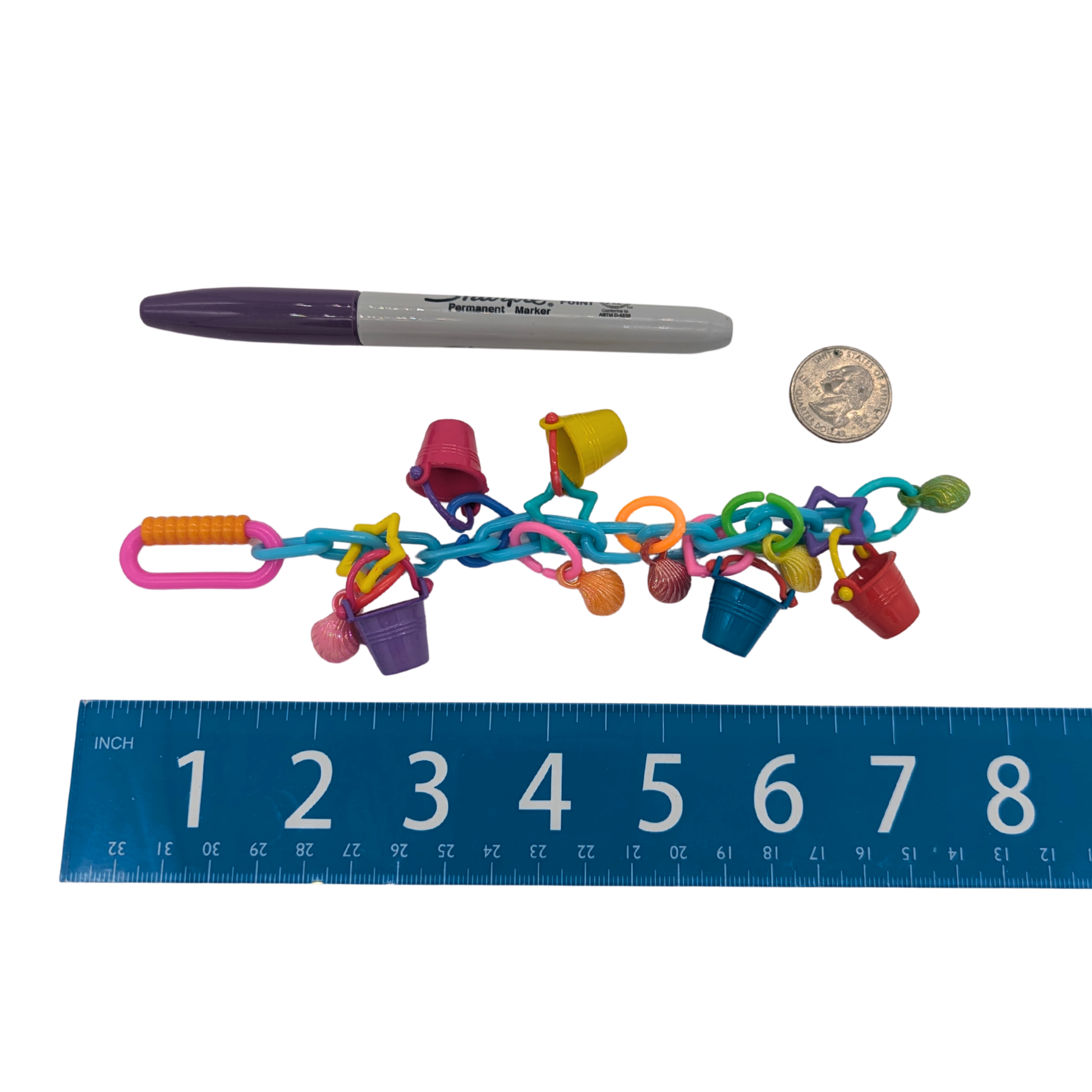 Seashore by Lil Monsters Bird Toys, next to a ruler, US quarter, and sharpie marker for scale. 