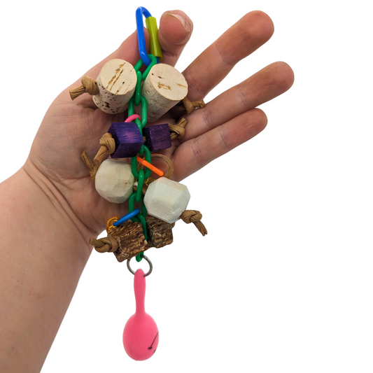 Shake Rattle and Chew bird toy by Lil Monsters Bird Toys, held in hand for scale