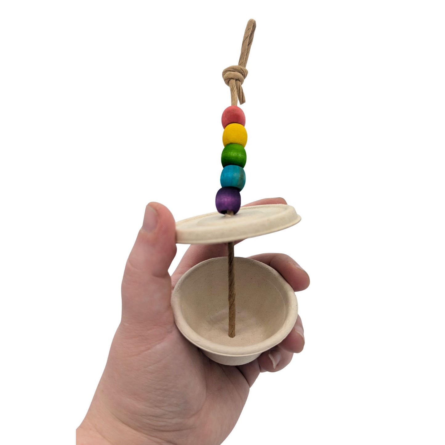 Souffle by Lil Monsters Bird Toys. Held in hand with the lid removed to show use. 