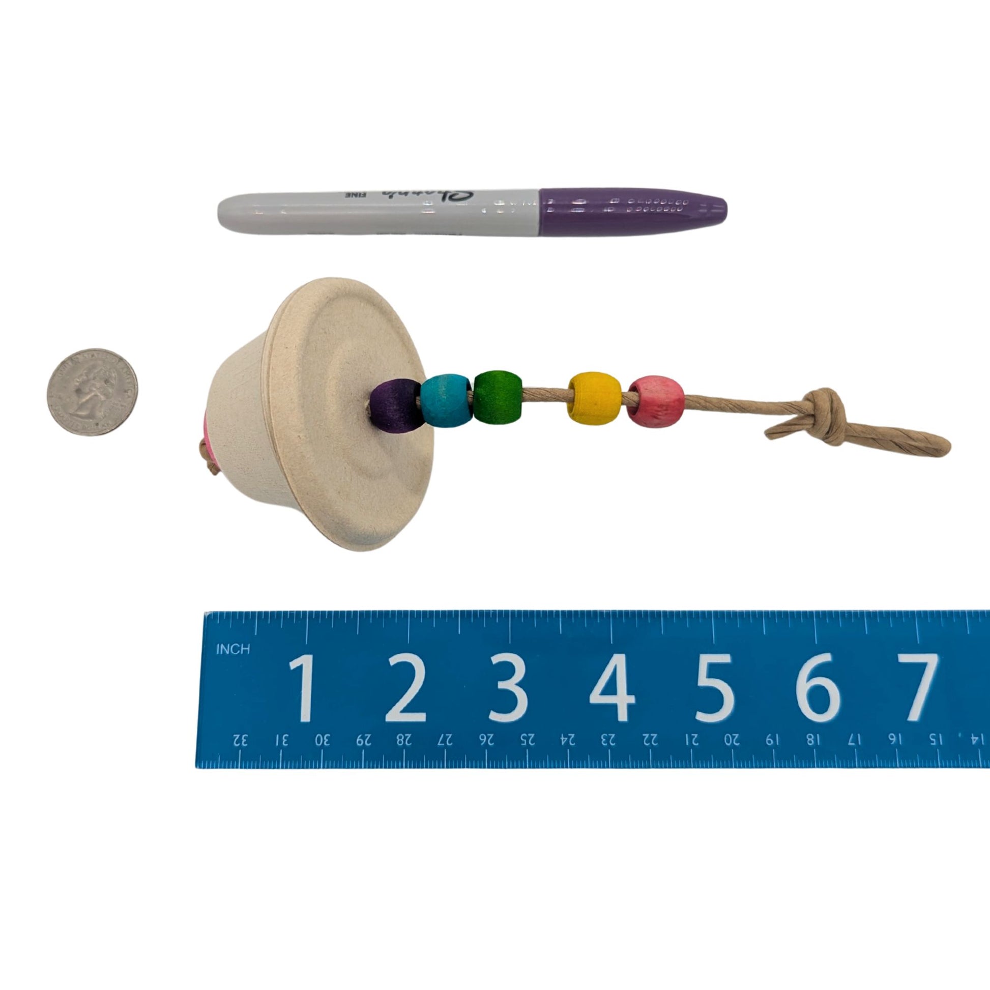 Souffle by Lil Monsters Bird Toys. Shown next to a ruler, US quarter, and sharpie marker for scale. 