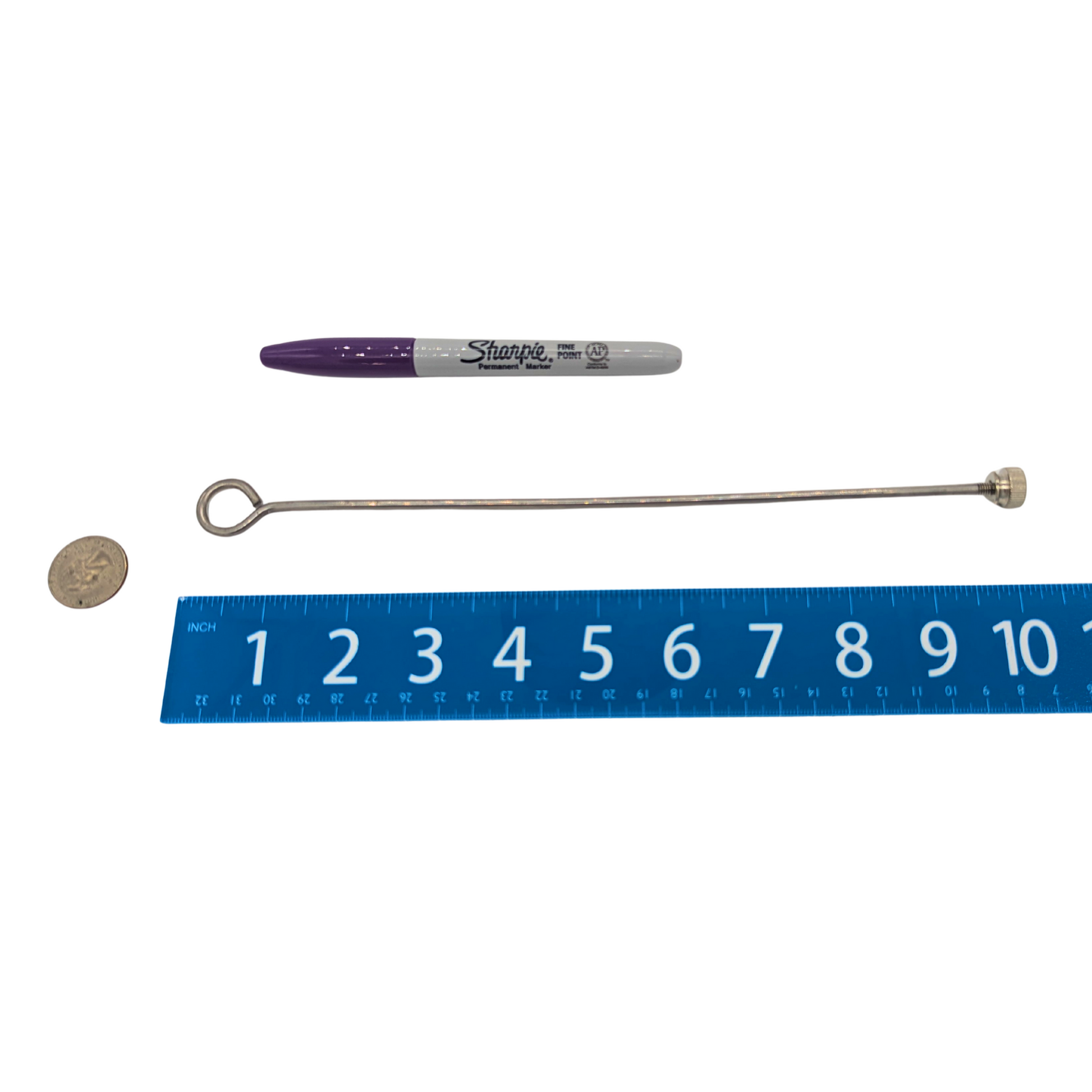 10 inch Stainless Steel Skewer by Super Bird Creations, next to a sharpie, ruler, and US quarter for scale