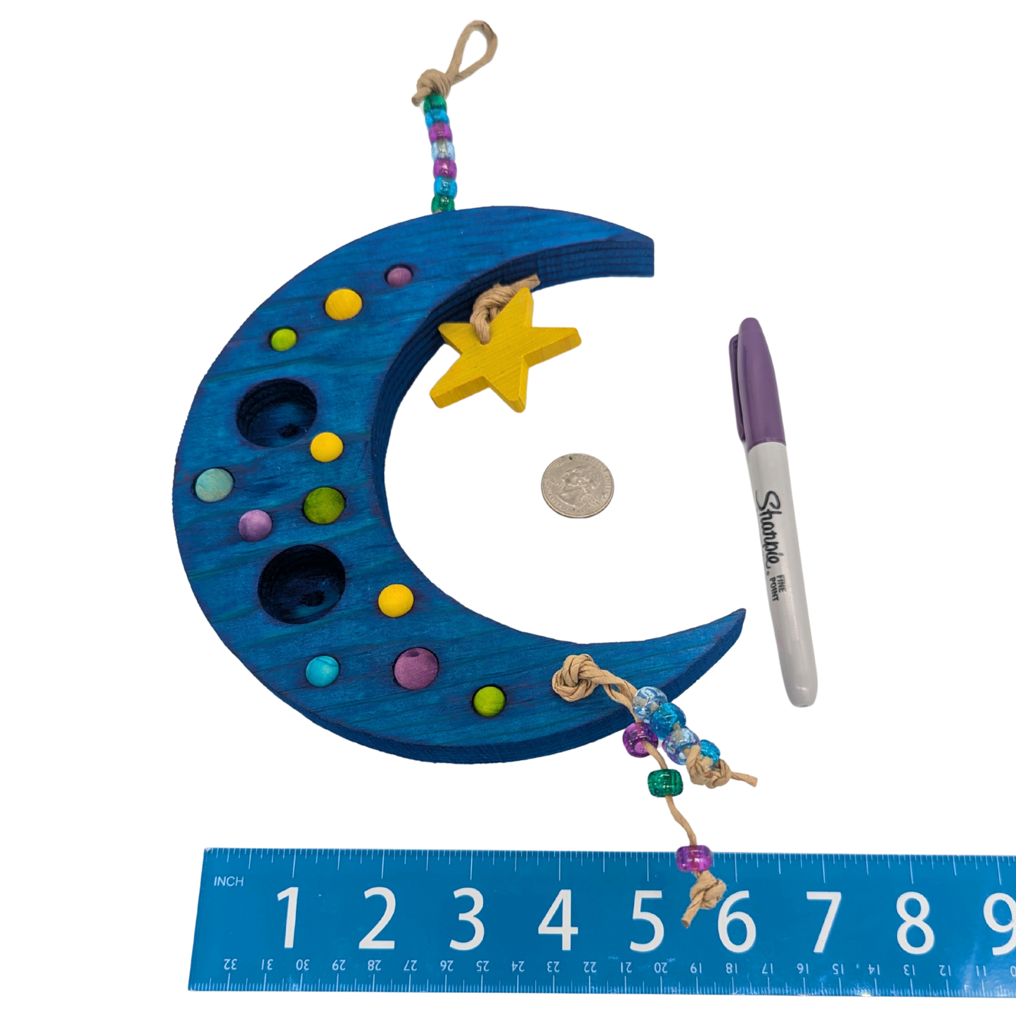 Sweet Dreams by Lil Monsters Bird Toys. A Crescent Moon Shaped Bird toy or swing, next to a ruler, US quarter, and sharpie marker for scale. 