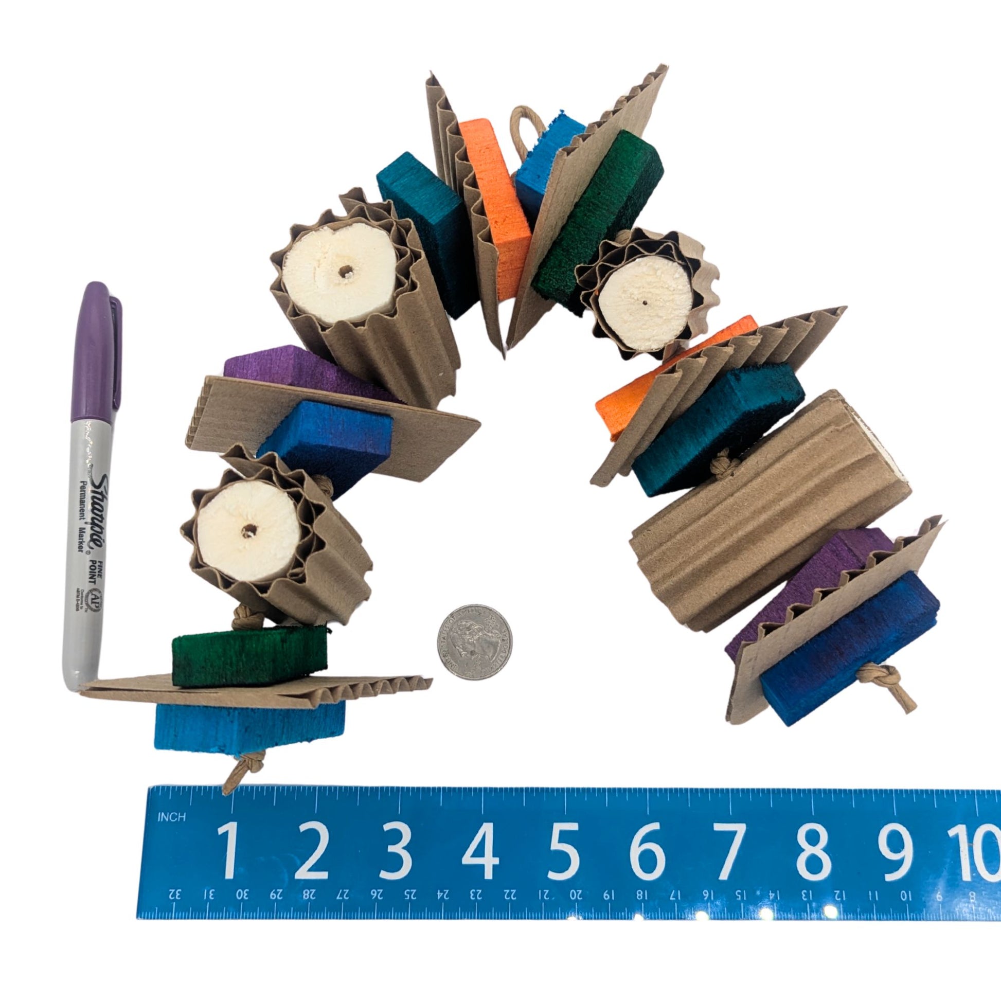 Tapioca by Lil Monsters Bird Toys. Shown next to a ruler, US quarter, and sharpie marker for scale. 