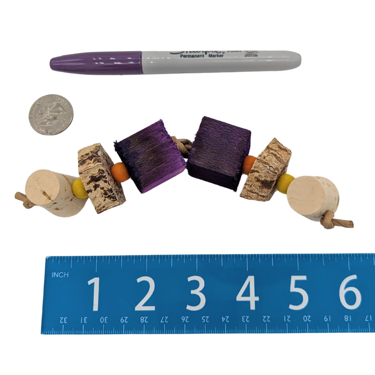 Trio by Lil Monsters Bird Toys. Shown next to a US quarter, sharpie marker, and ruler for scale. 