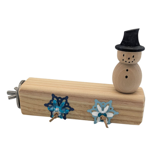 Winter Wonderland by Lil Monsters Bird Toys. A Winter themed bird perch with a wooden snowman, and adorned with plastic and cardstock snowflakes. Includes stainless steel hardware. 