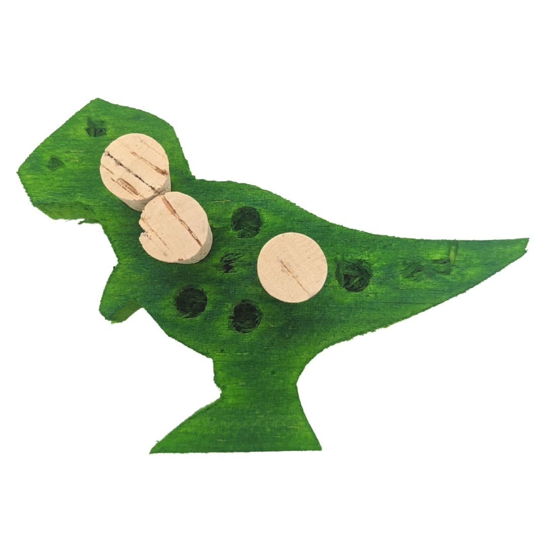 Balsasaurus Rex by Lil Monsters Bird Toys. A piece of balsa cut into the shape of a t-rex dinosaur. Embedded with cork stoppers, and has holes ready to be filled with treats. Shown in a green color.