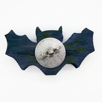 A bat shaped piece of pine. A Halloween themed toy for small parrots such as conures, cockatiels. budgies, parakeets, ringnecks and more. Shown with stainless steel hardware .