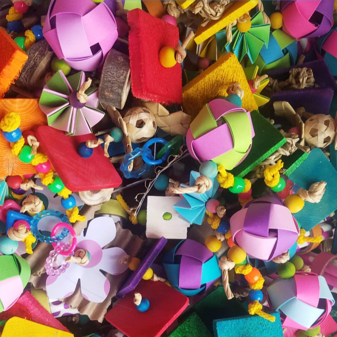 A mix of brightly colored random foot toys, sola as a Foot Toy Grab Bag by Lil Monsters Bird Toys