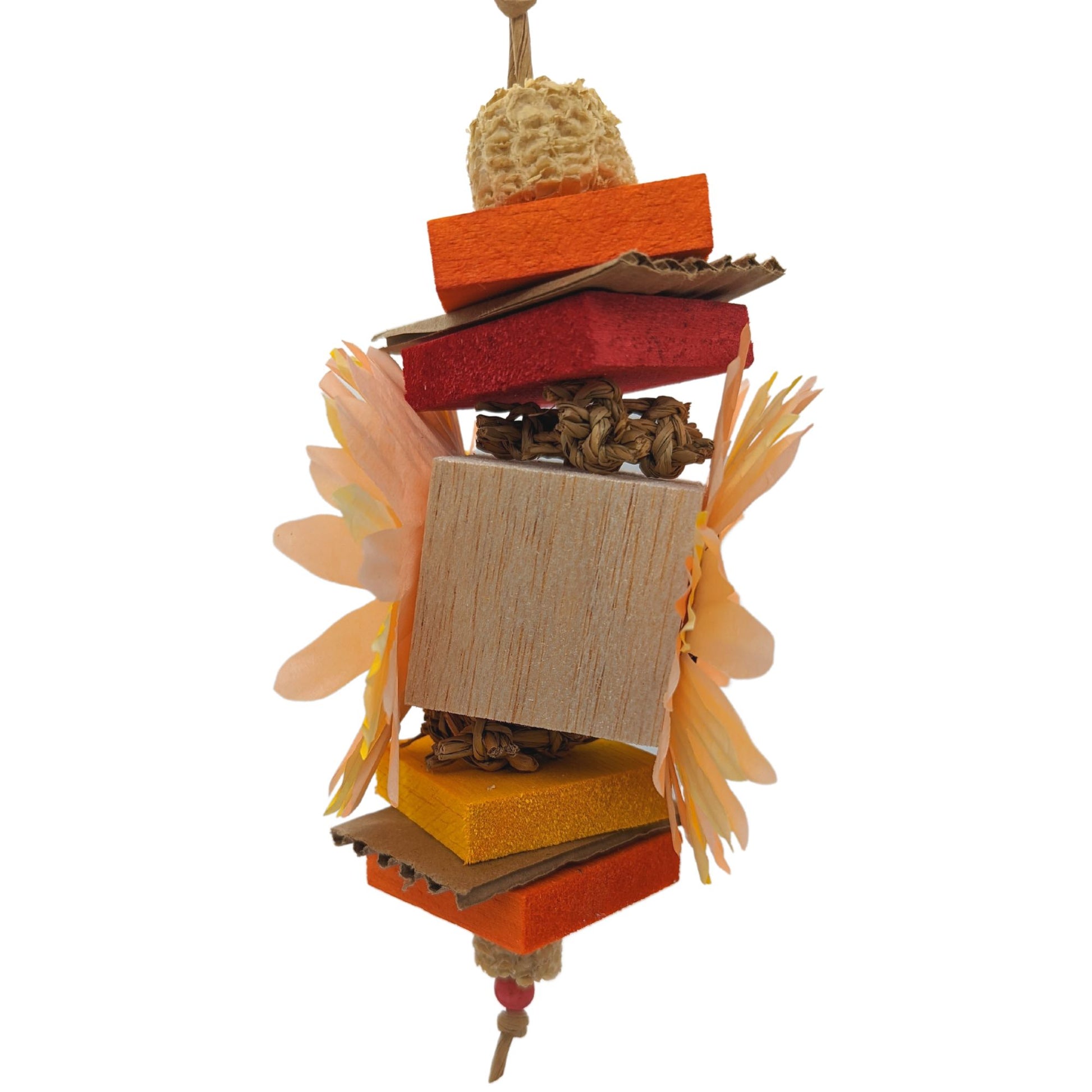 Side view of a bird toy. In order of appearance: corn cob, balsa, cardboard, balsa, seagrass, 2" balsa block, seagrass, balsa, cardboard, balsa, corn cob, bead. 