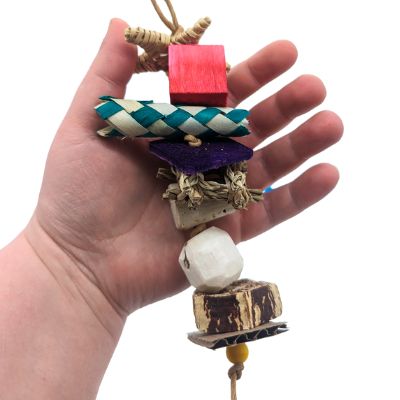 Lazy Monster Sampler by Lil Monsters Bird Toys, held in hand for scale