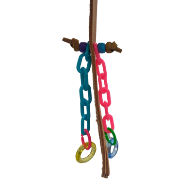 Side view of a bird toy with a leather base and plastic additions on a white background. 