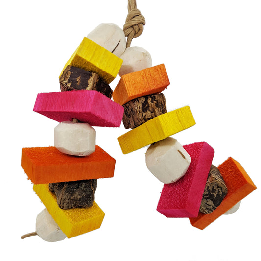 A small parrot toy, made with alternating sola balls, half inch balsa slats, and mahogany pod slices. 