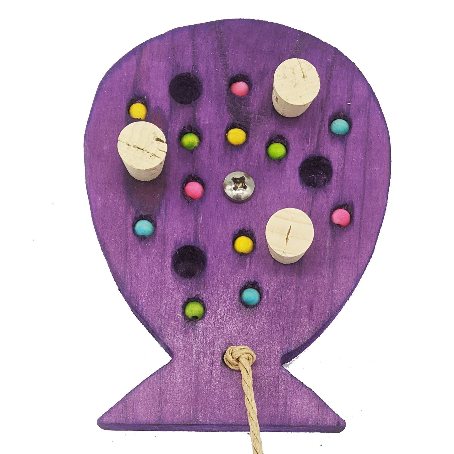 A birthday balloon shaped piece of pine, with embedded corks, and wooden beads,