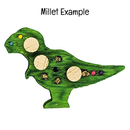 A T-Rex shaped piece of balsa. Shown as an example of the millet option. Embedded with 4mm and 6mm wooden beads, and millet, and three cork stoppers.