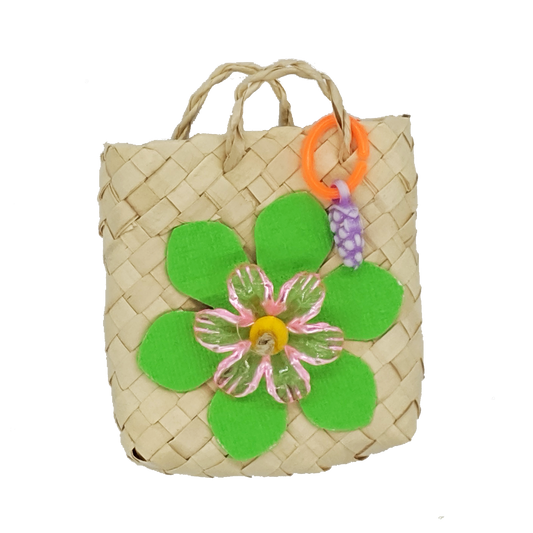 A woven palm bag with cardstock leaves, acrylic flower, and fruit charm. 