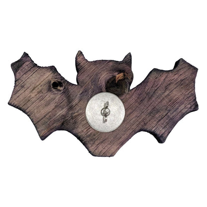 A bat shaped piece of pine shown with stainless steel hardware