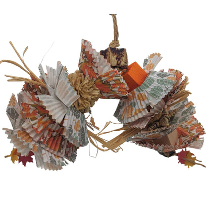 Duffy by Lil Monsters Bird Toys. A colorful bird toy made of mahogany pods, cupcake papers, and other natural materials designed to resemble decaying leaves.
