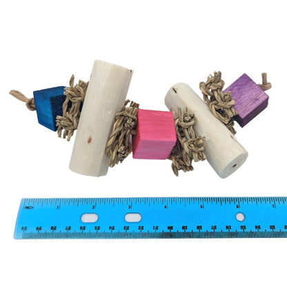 Balsa cubes and sola logs separated by seagrass squares on paper rope.  Shown next to a ruler showing about 7-8" long