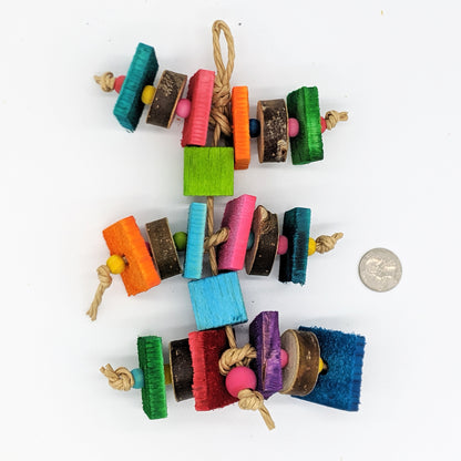 A bird toy for birds that love wood! Alternating pieces of 1/4" thin pine cut against the grain with pieces of natural willow or cottonwood slices. Wooden beads between the slices of wood, and balsa blocks between the levels of the toy. 